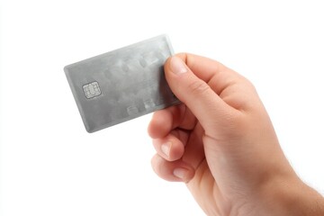 Hand holding a silver card with embedded chip against a plain white background during a financial transaction