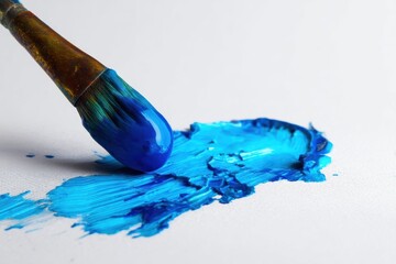 Macro view of spilled blue paint revealing brush strokes on white canvas surface