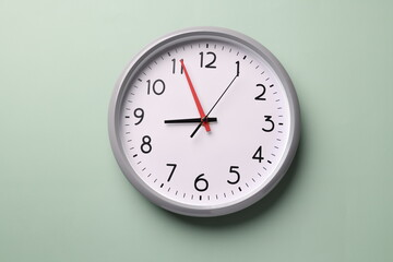 Close-up of a wall clock. The concept of time and work time is valuable for life, Alarm clock stopped. photo in a coloured background