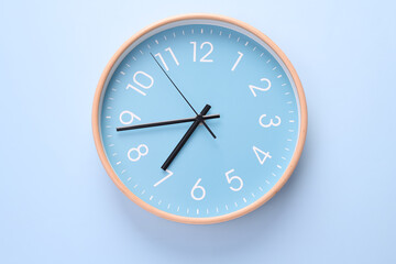 Close-up of a wall clock. The concept of time and work time is valuable for life, Alarm clock stopped. photo in a coloured background