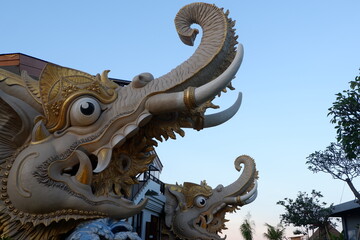 Majestic Elephant Statues Adorn a Building, Showcasing Intricate Carvings and Golden Accents