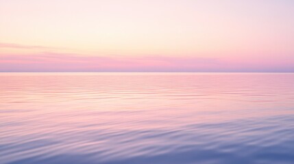 Peaceful water reflecting soft colors from a tranquil horizon