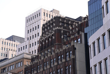 Fototapeta premium the tops of buildings. The primary building is brown with repeating architectural designs.