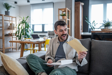 Excited freelancer receiving good news in a letter at home office