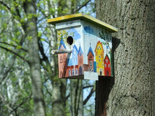 a birdhouse with a picture of an old european town on it