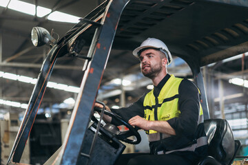 Engineers work in the factory. Technicians repair the engine. A worker drives a forklift in the warehouse. © NewSaetiew