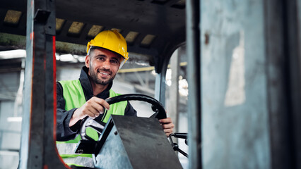 Engineers work in the factory. Technicians repair the engine. A worker drives a forklift in the...