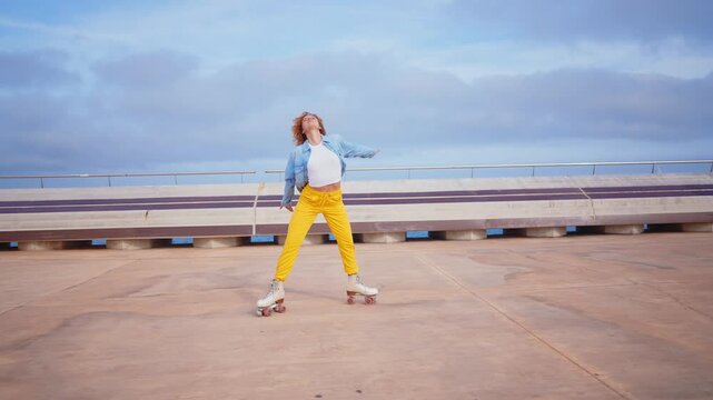 Happy young woman roller skating  and dancing outdoor in the city.