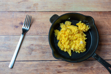 scrabmled eggs in a frying pan