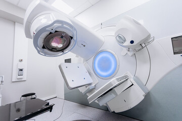 Empty radiotherapy treatment room with linear accelerator ready for use. The clean, modern medical...