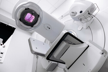 A radiation therapy machine is located in a state-of-the-art medical facility, ready for use in...