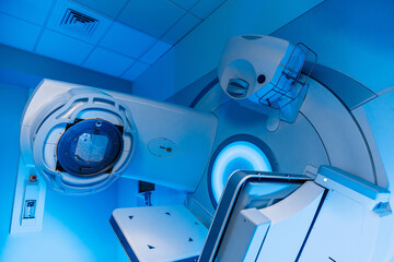 A radiation therapy machine is located in a state-of-the-art medical facility, ready for use in...