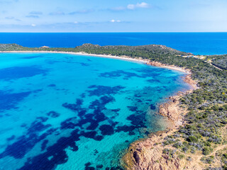 Fototapeta premium Drone view of Capo Coda Cavallo shore under a blue sky