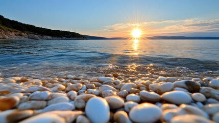 Obraz premium Sunrise over calm ocean shore, pebbles