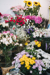 Floral display of fresh artisan bouquets at local flower shop featuring roses, sunflowers, carnations, and hydrangeas. small business trends, and handcrafted floral design