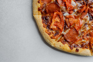 Delicious pizza with toppings on a gray countertop during daytime
