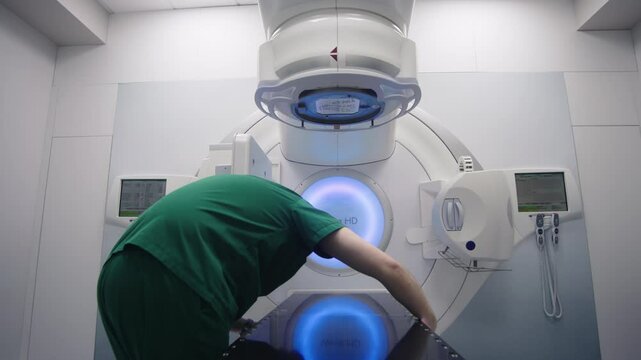 Medical specialists prepare the equipment for radiation therapy in a modern clinic before the procedure. The concept of medical technology and therapy for cancer patients.