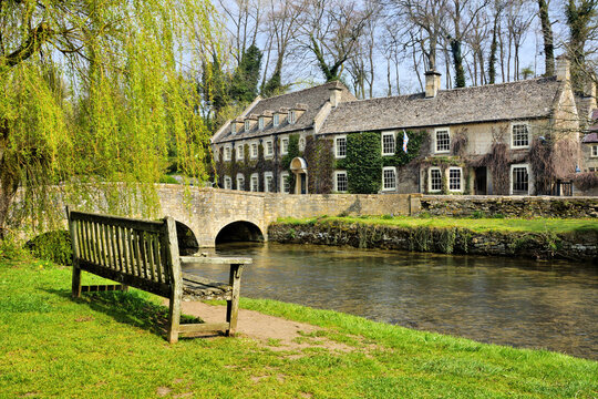 Beautiful Cotwolds with bench overlooking the cottages of Bibury, Gloucestershire, England, UK