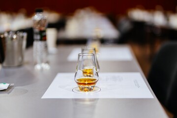 Reflection of golden whiskey in elegant glasses on a banquet table