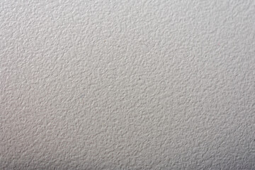White wall with a very rough texture. The wall is very plain and has no decoration.