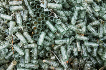 Empty glass sauce jars (industrial glass container) piled high, production has stopped, production slump, non returned empties concept. Jars background