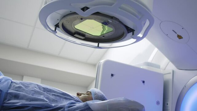 In a modern oncology clinic, a man is prepared for radiation therapy on a modern linear accelerator. Modern approaches to the treatment of oncology.