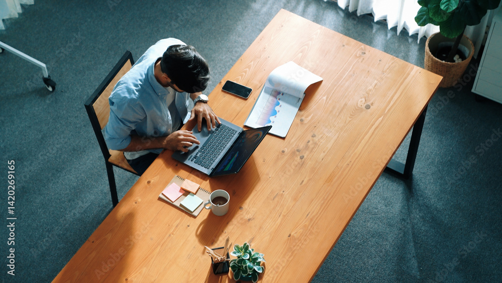 Poster top view of business man working on laptop while looking at financial chart. manager with casual clo