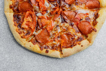 Delicious pepperoni pizza served on a stone countertop for casual dining