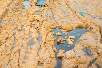 Sandstone bedrock, patterns of cracks and fissures, Malta. Secluded bays and beautiful coastline in Malta	
