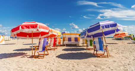 Summer vacation. Beach vacation at sea in summer. Travel agency. Sea relax under umbrella. Travel to sea. Sand exotic beach with umbrella. Sunny weather at beach sun. Hot beach weekend