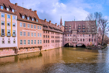 Obraz premium The Heilig-Geist-Hospital or The Holy Spirit Hospital. It was built in 1332 and 1339 along with a church. It was destroyed in the II W War and was reconstructed in 1951-53. Nuremberg, Germany, 2020