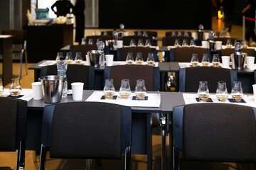 Tables arranged for an elegant whiskey tasting event in a modern venue