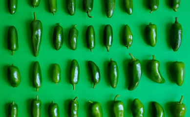 Top view of green peppers in green background