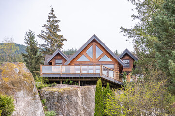 Two story stucco luxury house with nice spring blossom landscape in Vancouver, Canada, North America. Day time on April 2025.