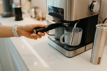 A couple is making coffee in the kitchen