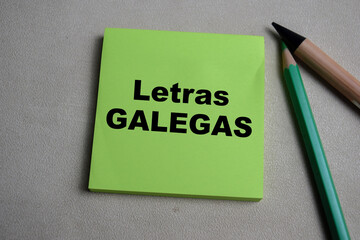 Concept of Letras Galegas write on sticky notes isolated on Wooden Table.