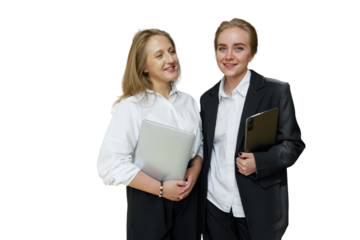 Two Confident Women in Professional Attire Share a Moment of Camaraderie While Holding Laptops in a Bright Studio