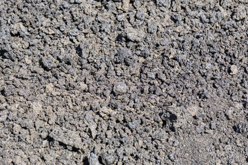 Solidified volcanic lava forming a rough textured surface. Backgrounds.