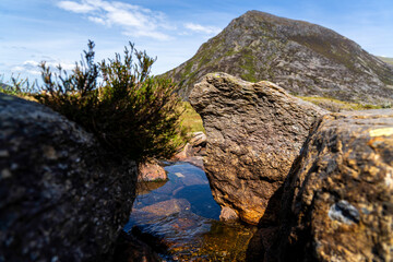 Close up of Lake Llyn Idwal's Lakeside Rocks within Cwm Idwal's Legendary Ice-Sculpted Hollow in Glyderau's Mountain Range in North Eryri (Snowdonia)