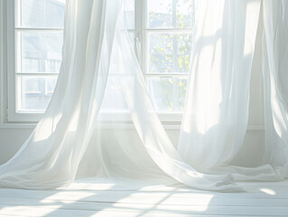 A window with white curtains softly blowing in