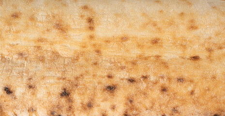 Focaccia flatbread slice macro texture, baked dough pattern. White bread loaf cut close up