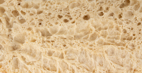 Focaccia flatbread slice macro texture, baked dough pattern. White bread loaf cut close up