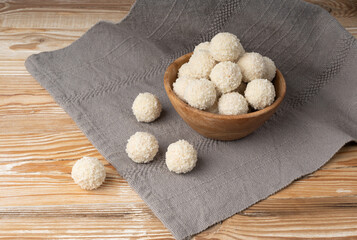 Coconut candies pile, coco ball. White truffle ball, indian ladoo or laddu with sweet cream and coco