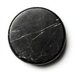 A close up shot of a worn black hockey puck on a white background plain