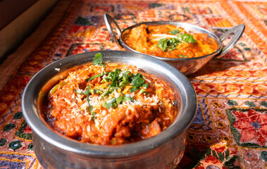 Lamb curry with tomatoes and fiery chili, traditional Indian Laal Maas served in a metal dish