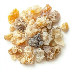 A close up view of a pile of frankincense resin pieces on white surface