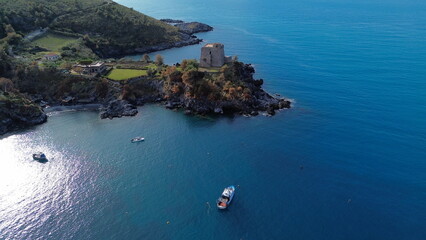 suggestive aerial view of blue sea of San nicola arcella beach located in Calabria in south Italy with old building of saracena tower named Torre Crawford in honor of famous American writer