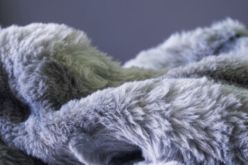 Soft and fluffy faux fur blanket in close-up detail, ideal for concepts of warmth, coziness, and...