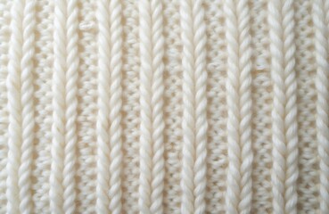 Close-up white knit wool textile material background. Soft warm knitted texture pattern ideal for cozy clothes design. Natural woven cotton canvas for fashion background.