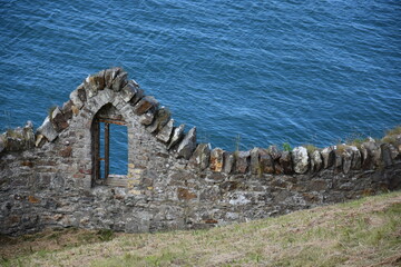 Vue sur l'océan à travers des ruines depuis la presqu'île de Howth en Irlande